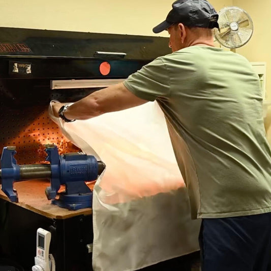 Two red fire blanket packages with a white fire blanket inside on a white background