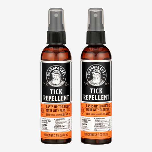 Two bottles of Grandpa Gus' Tick Repellent on a white background