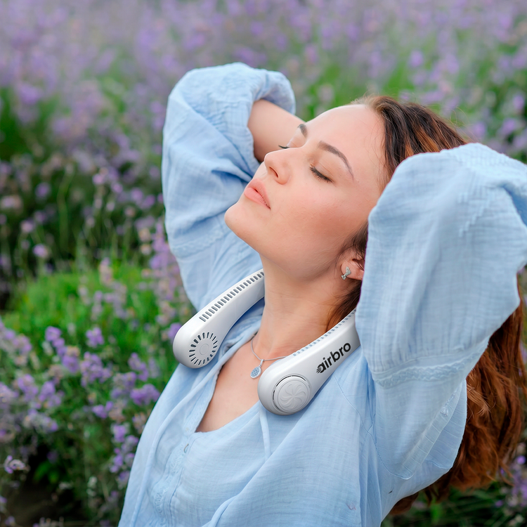 Woman using an airBreez device in a lavender field