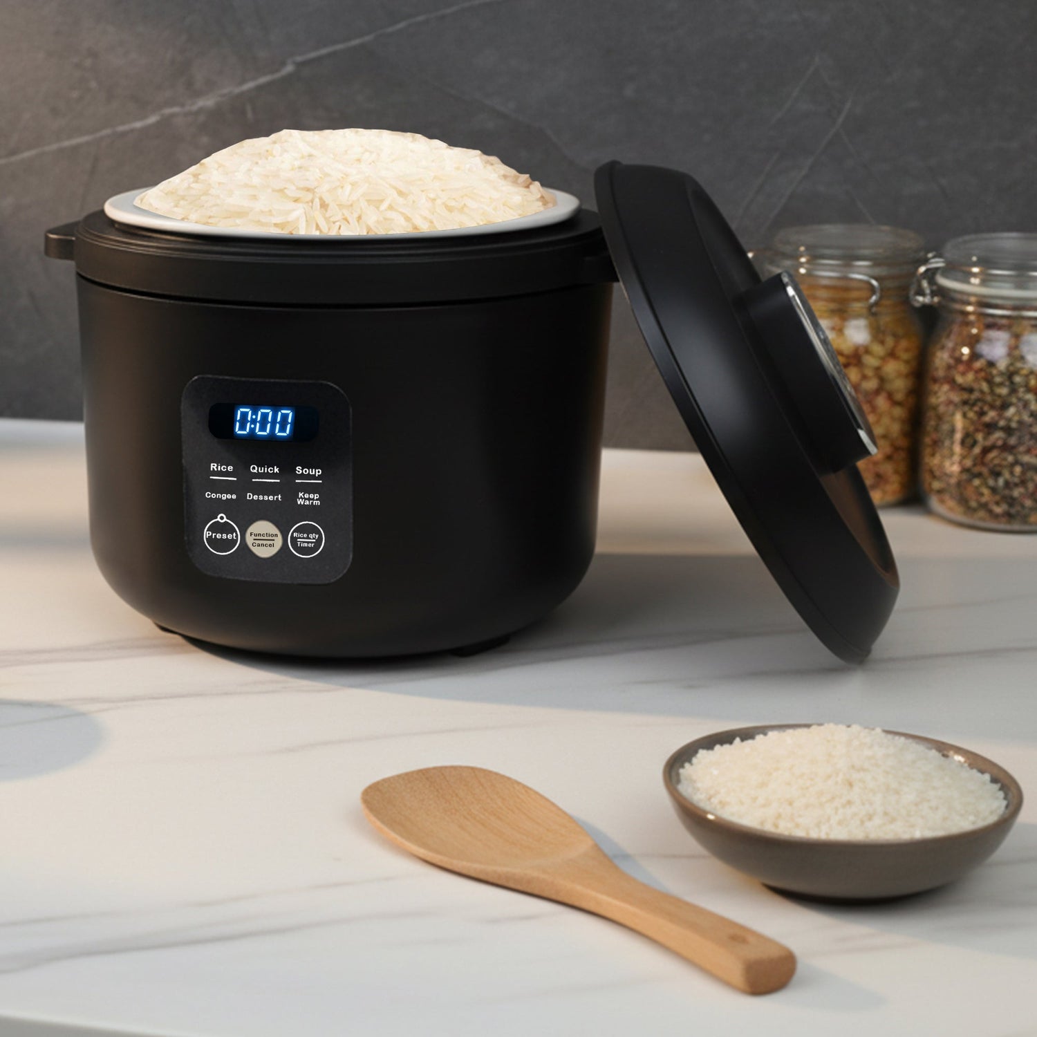 Black rice cooker with digital display on a light wooden surface, surrounded by jars of grains and a bowl of rice.