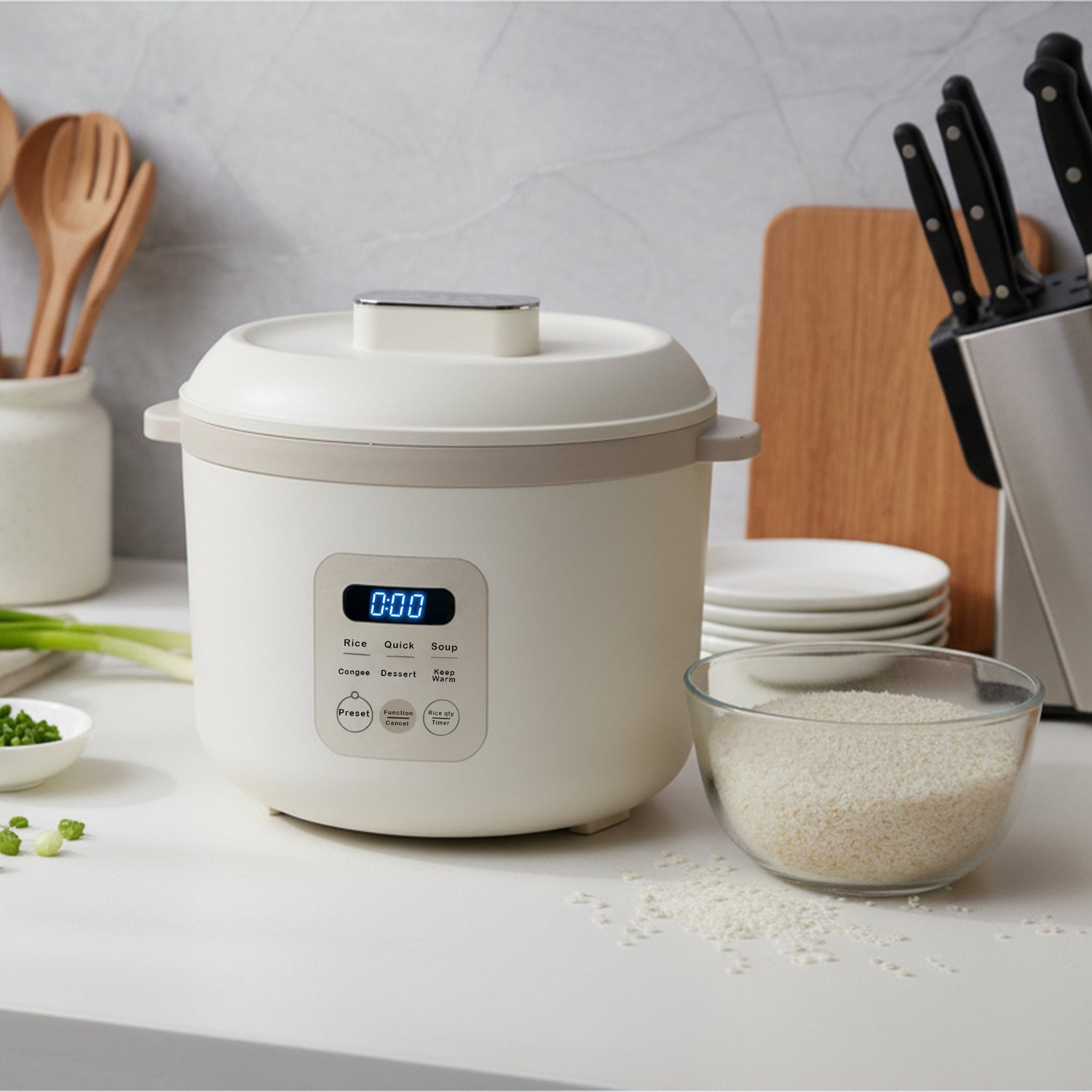 White rice cooker on a kitchen counter with a bowl of rice and kitchen utensils in the background.