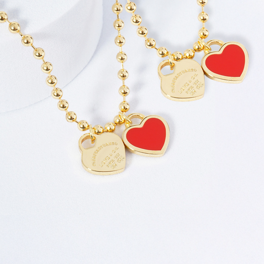Two necklaces on mannequin busts with a blurred background