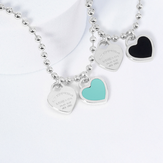 Two necklaces on mannequin busts with a blurred background