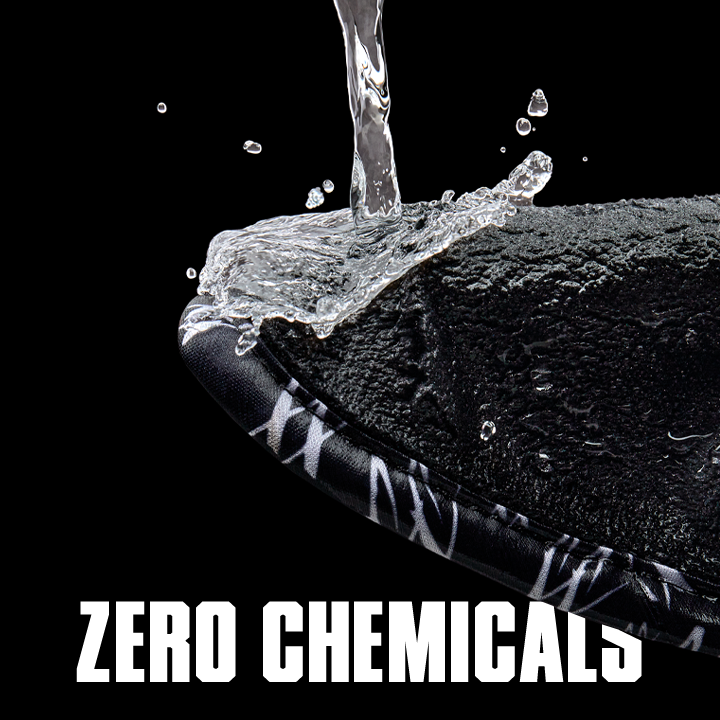 Water droplet falling onto a textured surface with 'Zero Chemicals' text on a black background