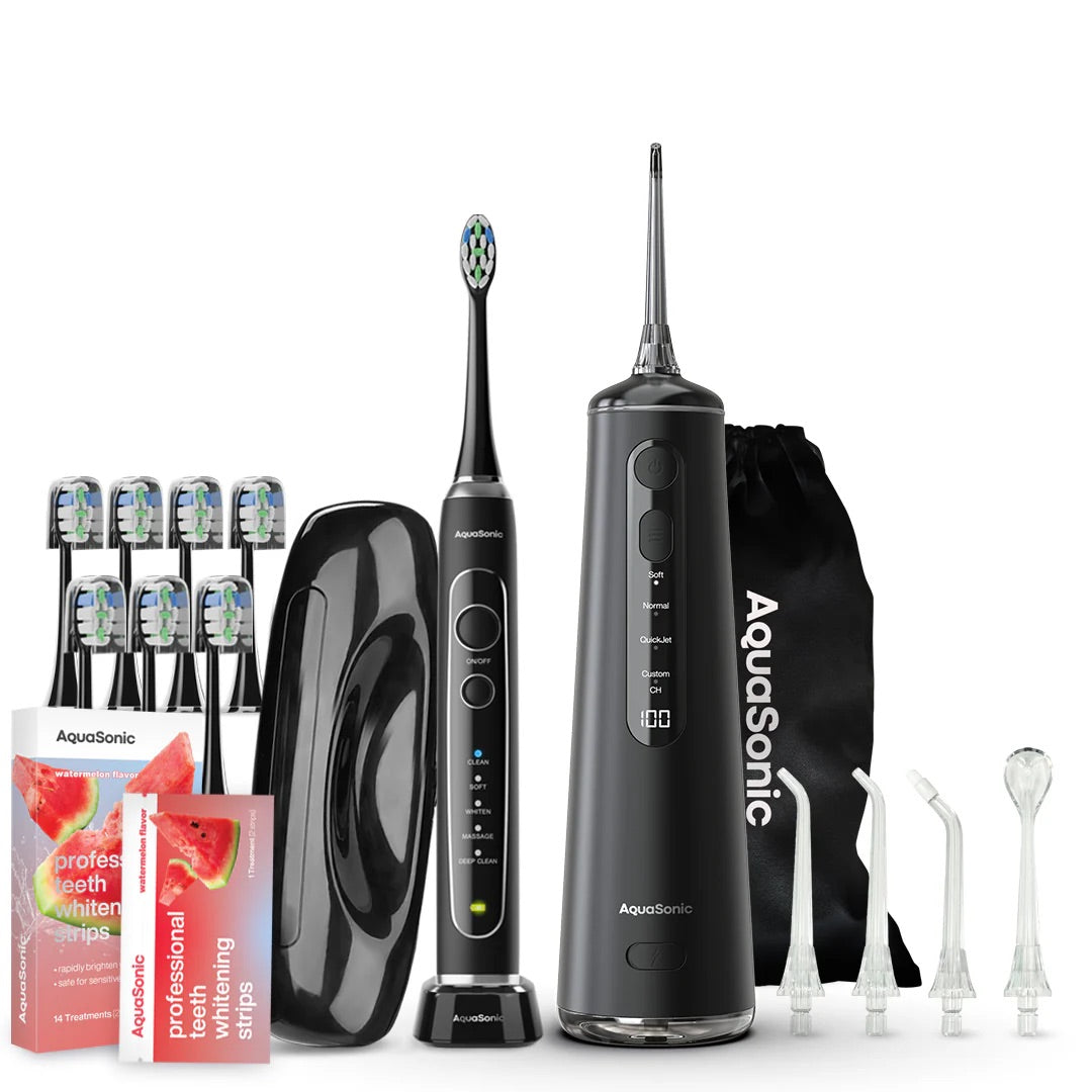 AquaSonic dental care product set including toothbrushes, water flosser, and whitening strips on a white background.