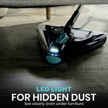 Vacuum cleaner head with LED light on a wooden floor, highlighting its feature for cleaning hidden dust.
