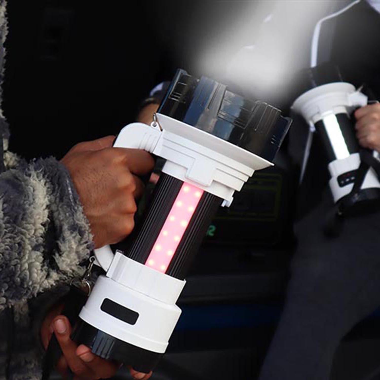 Person holding a futuristic light saber-like device with multiple lights and colors.