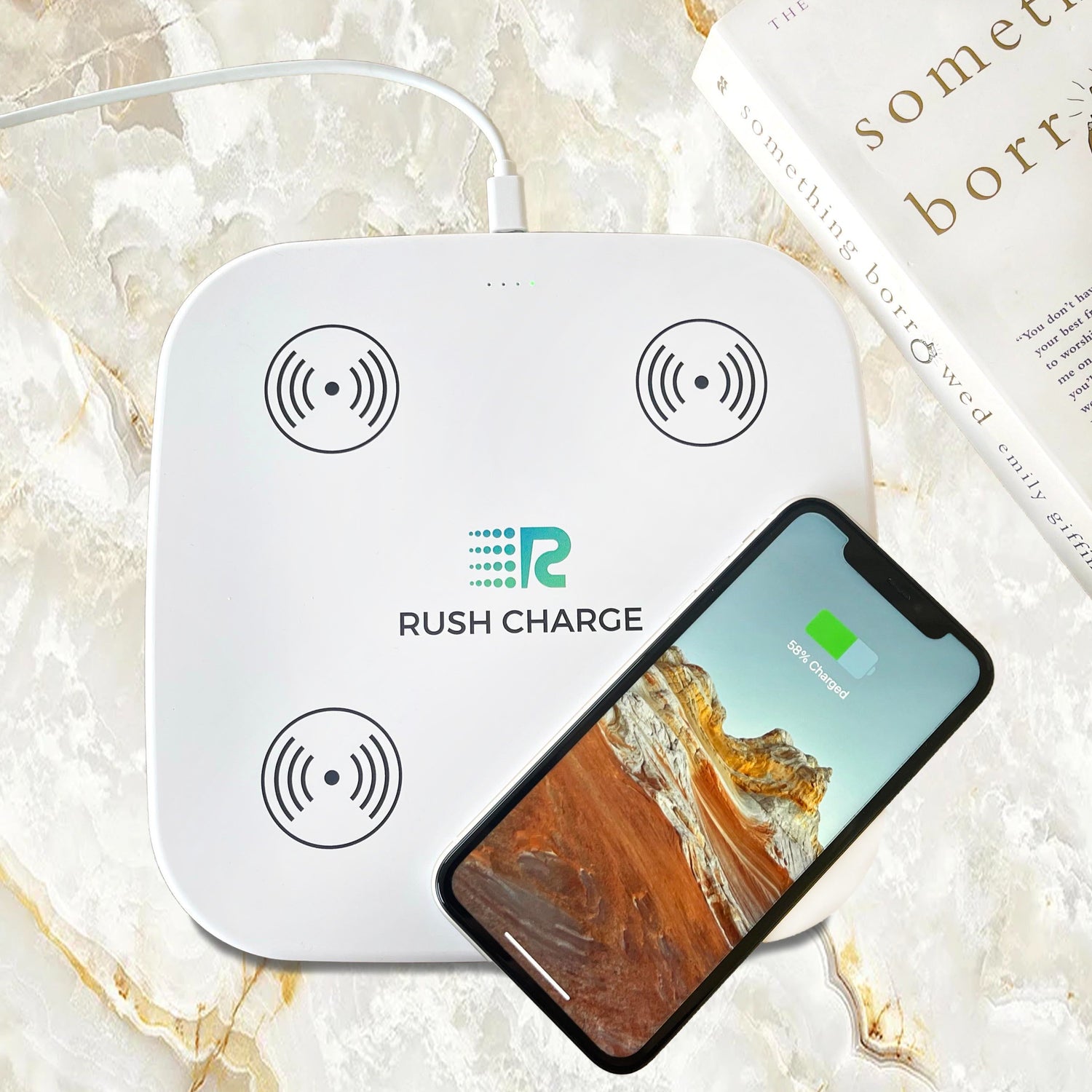 Wireless charging pad with 'Rush Charge' branding and a smartphone on a marble surface.