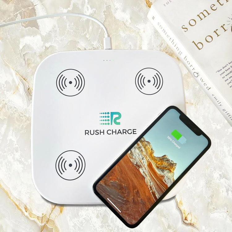 Wireless charging pad with 'Rush Charge' branding and a smartphone on a marble surface.