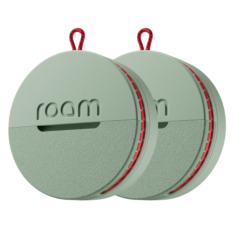2-pack sage green Roam smart trackers with red elastic strap on transparent background showing compact round design with Roam branding
