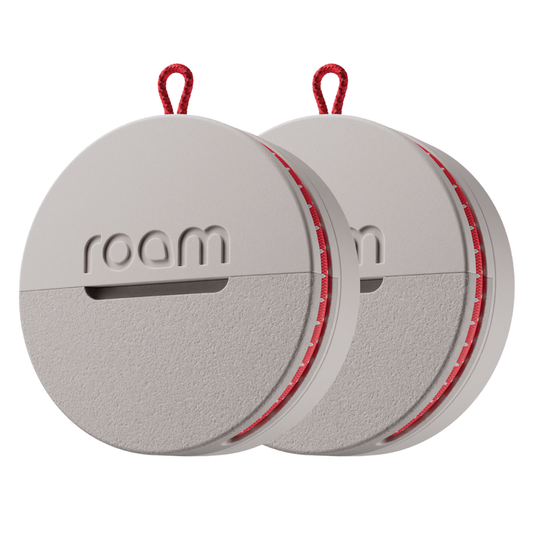 Roam smart tracker 2-pack in grey color with red accents and red loop attachments, circular GPS trackers with 'roam' branding on transparent background