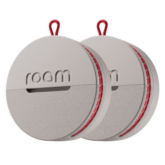 Roam smart tracker 2-pack in grey color with red accents and red loop attachments, circular GPS trackers with 'roam' branding on transparent background