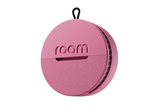 Roam smart tracker single unit in pink color with 'roam' branding on transparent background, compact circular GPS tracker with loop attachment