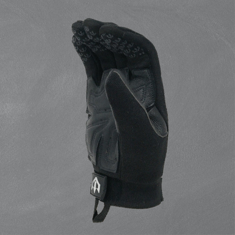 Black glove with textured palm on a gray background
