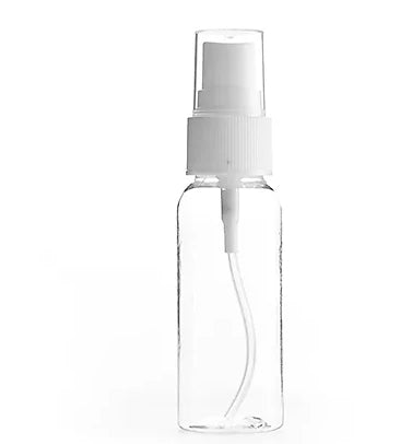 Clear spray bottle with white cap on a white background