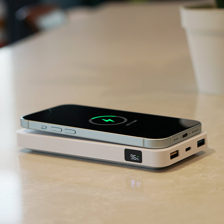 Wireless charging pad with smartphone on a table