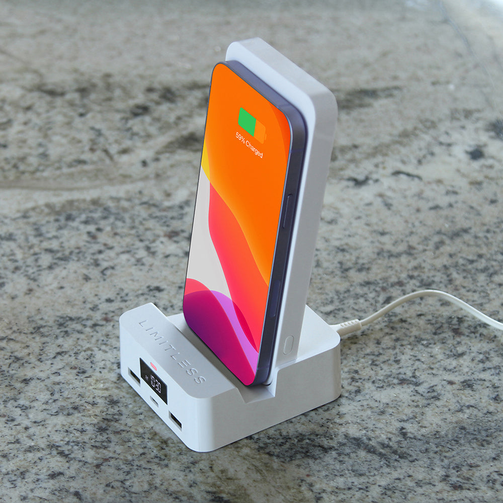 Phone on a charging stand with a smartphone displaying a colorful app interface.