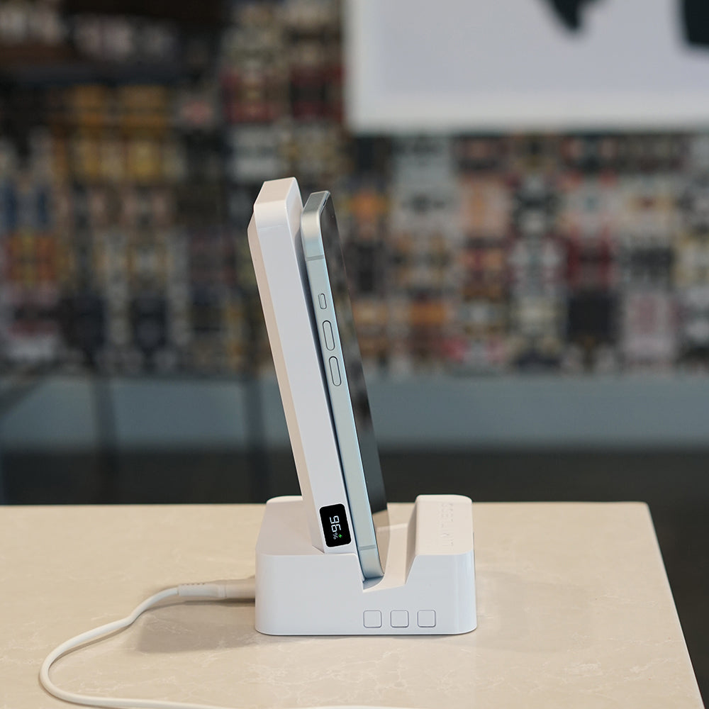White electronic device on a stand with a blurred background