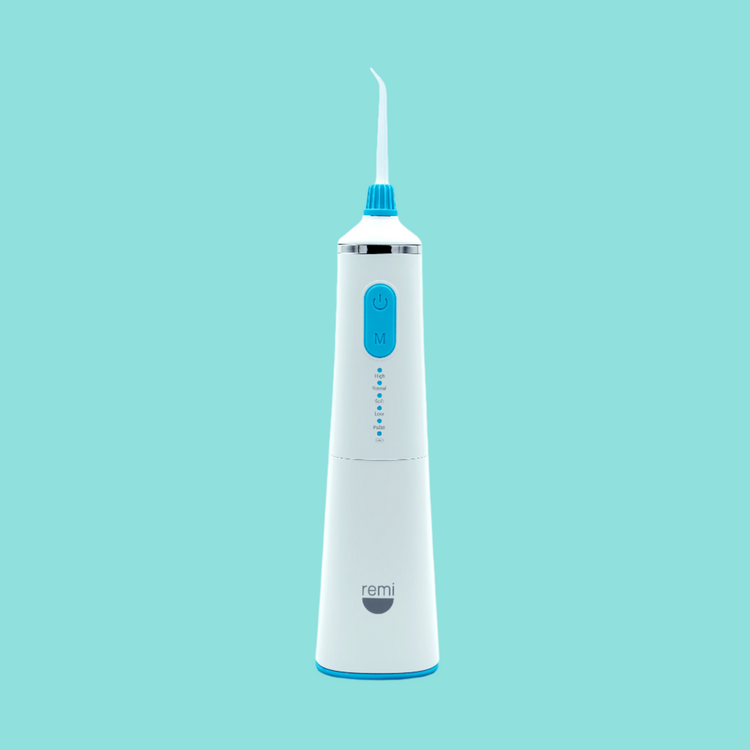 White and blue dental water flosser on a light blue background