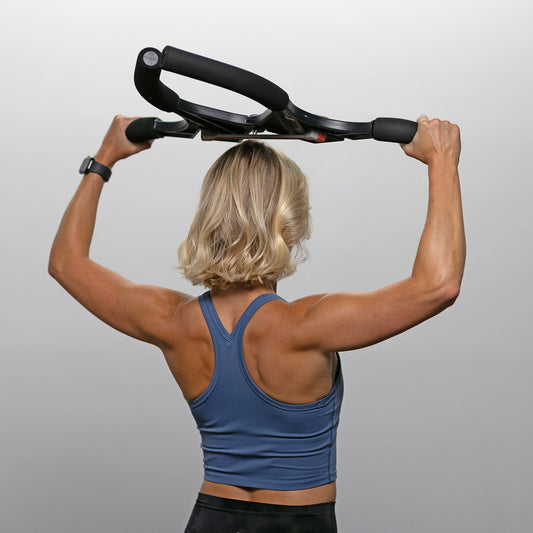 Black and red cross trainer on a gray background