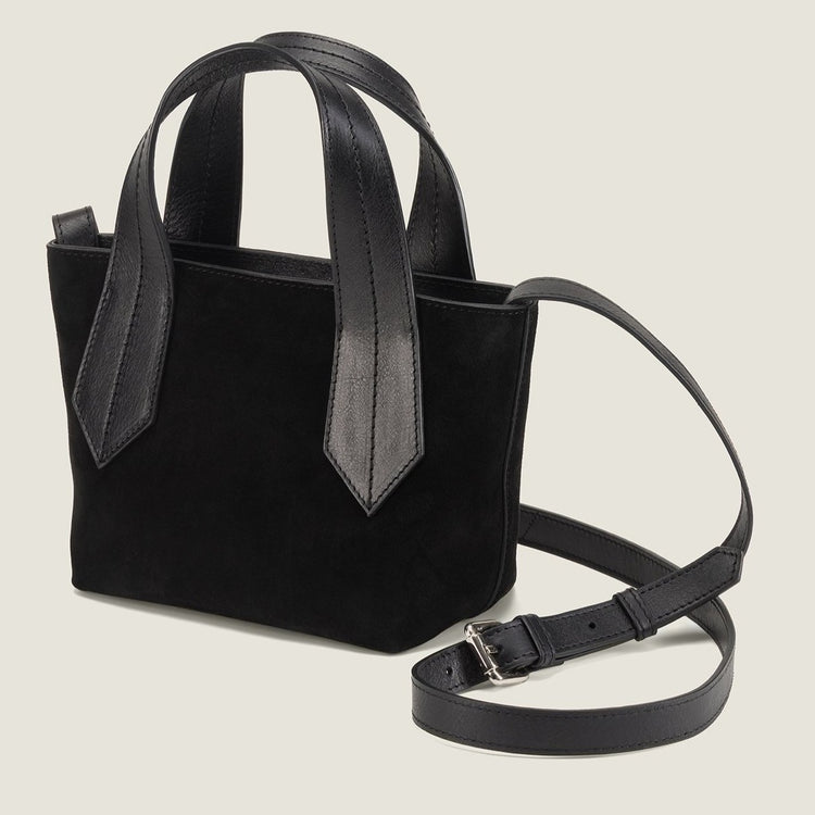 SIDE SHOT OF THE TAB TOTE MINI IN BLACK SUEDE AND CROSSBODY STRAP