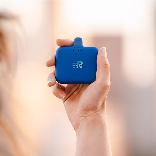 A compact and portable black charger with a logo on the front, featuring a single charging port.